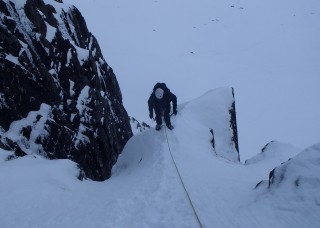 Guy relaxing after the crux